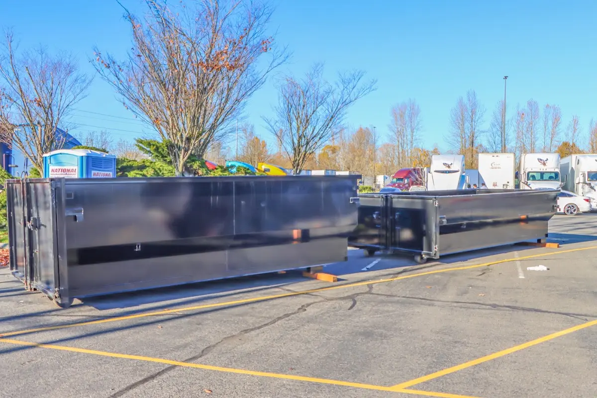 Professional dumpster rental service with roll-off container on residential driveway in Marilla